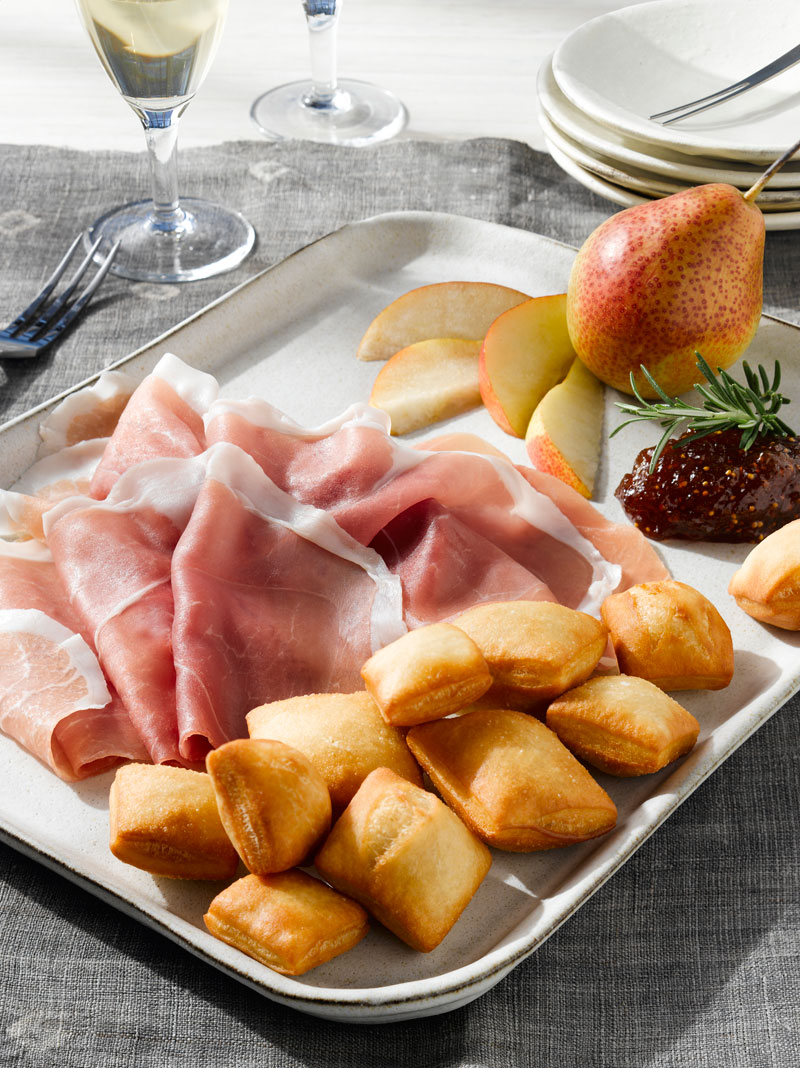 Piccolo Sogno signature dishes Ravioli Piccolo Sogno (Four Cheese Ravioli)Branzino al Sale (Salt-Crusted Sea Bass)Prosciutto di Parma with Gnocco Fritto
